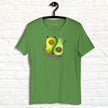 Matcha green Avocado Yoga Tee on a hanger, highlighting the fun yoga‑posing avocado characters with clean outlines and a wellness‑inspired vibe.