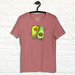 Rosewood Avocado Yoga Tee displayed on a hanger, featuring two adorable avocados practicing yoga with friendly faces and a warm, cozy color palette.