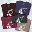 Stack of folded Chill Bunny Line Art Tees in assorted colors, each showing the minimalist rabbit outline.