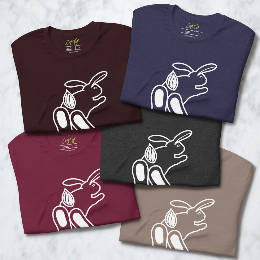 Stack of folded Chill Bunny Line Art Tees in assorted colors, each showing the minimalist rabbit outline.