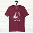 Chill Bunny Line Art Tee hanging against a white brick wall, showing the relaxed rabbit outline on a maroon shirt.