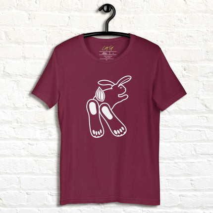 Chill Bunny Line Art Tee hanging against a white brick wall, showing the relaxed rabbit outline on a maroon shirt.