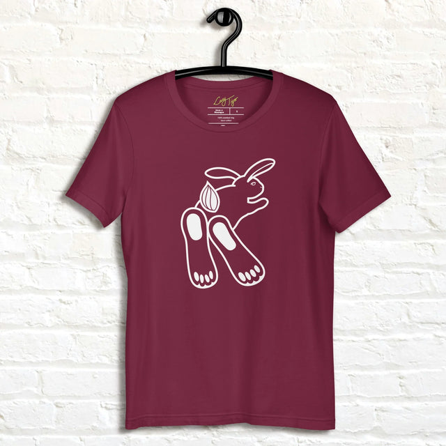 Chill Bunny Line Art Tee hanging against a white brick wall, showing the relaxed rabbit outline on a maroon shirt.