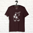Chill Bunny Line Art Tee hanging against a white brick wall, showing the relaxed rabbit outline on a dark brown shirt.