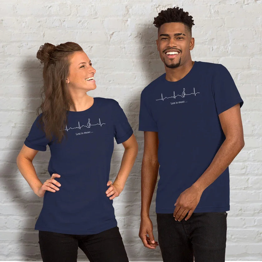 Two people wearing matching navy Lost in Music Line Art Tees, featuring the heartbeat‑wave treble‑clef design and ‘Lost in music…’ text in white.