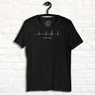 Black Heartbeat Music Tee on a hanger featuring the clean ECG‑style heartbeat line merging into a treble clef with the text ‘Lost in music…,’ printed in high‑contrast white on smooth black cotton