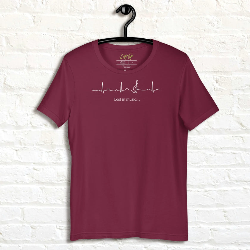 Burgundy Heartbeat Music Tee displayed on a hanger showing the minimalist ECG‑inspired heartbeat line transitioning into a treble clef with ‘Lost in music…,’ printed in bright white on breathable cotton
