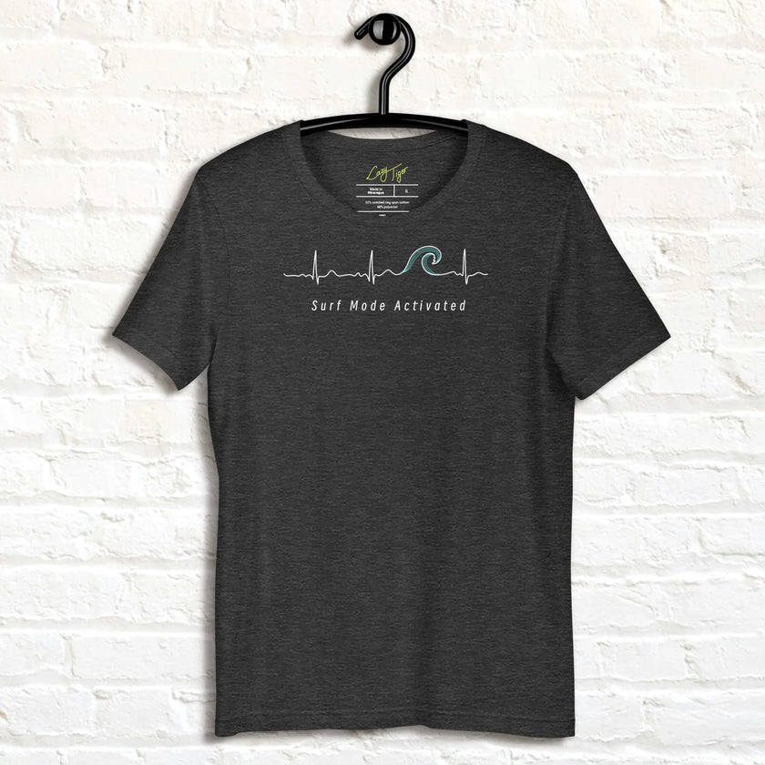 Heather charcoal Surf Mode Activated Tee on a hanger, highlighting the clean white heartbeat‑wave design and coastal‑inspired typography.