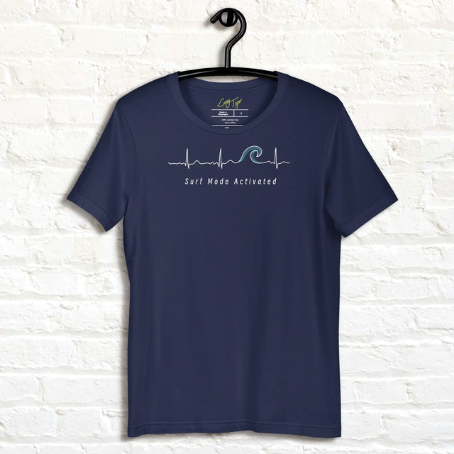 Navy Surf Mode Activated Tee hanging against a white wall, showing the minimalist heartbeat line transforming into a surf wave with the ‘Surf Mode Activated’ script.