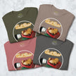 Four folded Lazy Potato Tees in olive green, taupe, rosewood and graphite grey, each showing the cute couch‑potato illustration with neon text.