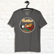 Graphite grey Lazy Potato Tee displayed on a hanger, featuring the cute potato lounging on a couch with a TV remote and glowing ‘Couch Potato’ text.