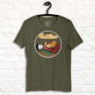 Olive green Lazy Potato Tee displayed on a hanger, showing the relaxed potato on a couch with glowing script and cozy living‑room details.