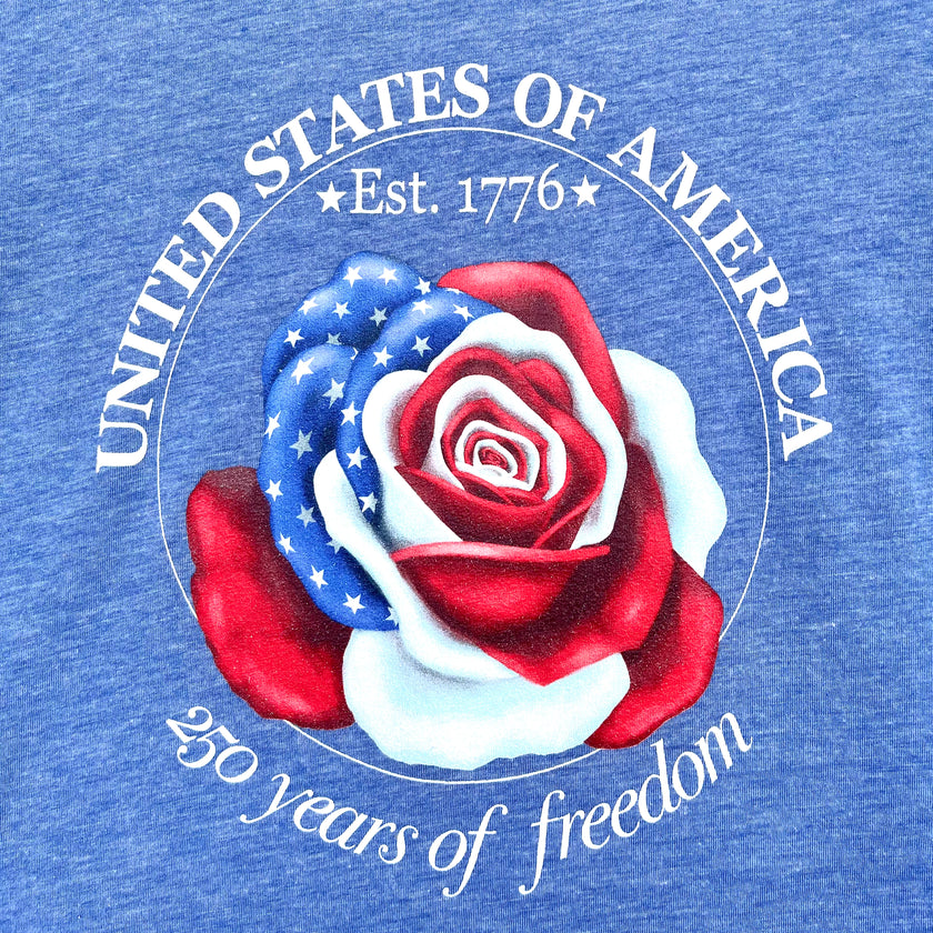 Real-life close-up photo of the Liberty Rose print on a vintage blue tee, highlighting the patriotic rose illustration and crisp circular text.