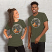 Couple wearing matching olive Pizza Raptor graphic tees, playful dinosaur eating pizza design for couples and pizza lovers.