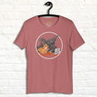 Rosewood pink T‑shirt on hanger with cute pizza raptor illustration, quirky dinosaur and pizza lover shirt.