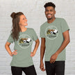 Couple wearing sage Procrasti‑NATION tees featuring sleepy animals, styled as a funny procrastination shirt and cute matching outfit idea.