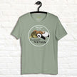 Sage green Procrasti‑NATION shirt on hanger featuring sleepy sloth, panda, and turtle graphic for procrastination and cozy aesthetic lovers.