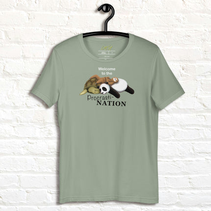 Sage green Procrasti‑NATION shirt on hanger featuring sleepy sloth, panda, and turtle graphic for procrastination and cozy aesthetic lovers.