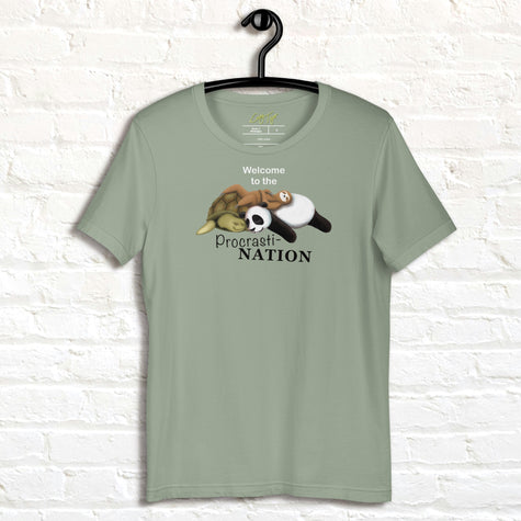 Sage green Procrasti‑NATION shirt on hanger featuring sleepy sloth, panda, and turtle graphic for procrastination and cozy aesthetic lovers.