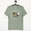 Sage green Procrasti‑NATION shirt on hanger featuring sleepy sloth, panda, and turtle graphic for procrastination and cozy aesthetic lovers.