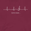 Closeup of the Heartbeat Music Tee in burgundy featuring an ECG‑style heartbeat line flowing into a treble clef with the text ‘Lost in music…,’ printed in crisp white on burgundy red cotton fabric.