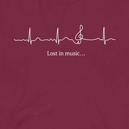 Closeup of the Heartbeat Music Tee in burgundy featuring an ECG‑style heartbeat line flowing into a treble clef with the text ‘Lost in music…,’ printed in crisp white on burgundy red cotton fabric.