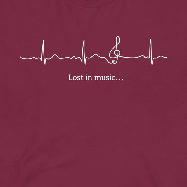 Closeup of the Heartbeat Music Tee in burgundy featuring an ECG‑style heartbeat line flowing into a treble clef with the text ‘Lost in music…,’ printed in crisp white on burgundy red cotton fabric.