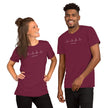 Two models wearing the burgundy Heartbeat Music Tee with the ECG‑style heartbeat‑to‑treble‑clef design and ‘Lost in music…’ text, styled in a modern, music‑lover aesthetic