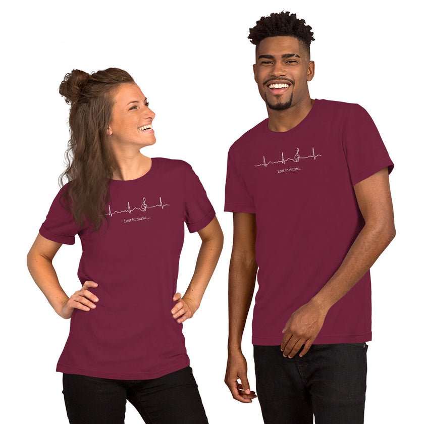 Two models wearing the burgundy Heartbeat Music Tee with the ECG‑style heartbeat‑to‑treble‑clef design and ‘Lost in music…’ text, styled in a modern, music‑lover aesthetic