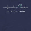 Closeup of the Heartbeat Surf Tee in dark blue featuring an ECG‑style minimalist heartbeat line flowing into a surf wave with the text ‘Surf Mode Activated,’ printed in crisp white on soft navy cotton fabric
