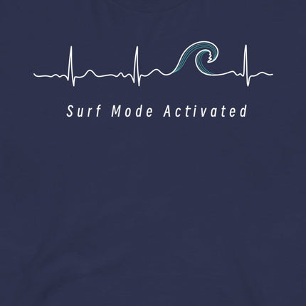 Closeup of the Heartbeat Surf Tee in dark blue featuring an ECG‑style minimalist heartbeat line flowing into a surf wave with the text ‘Surf Mode Activated,’ printed in crisp white on soft navy cotton fabric