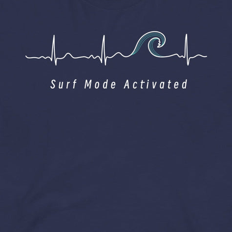 Closeup of the Heartbeat Surf Tee in dark blue featuring an ECG‑style minimalist heartbeat line flowing into a surf wave with the text ‘Surf Mode Activated,’ printed in crisp white on soft navy cotton fabric