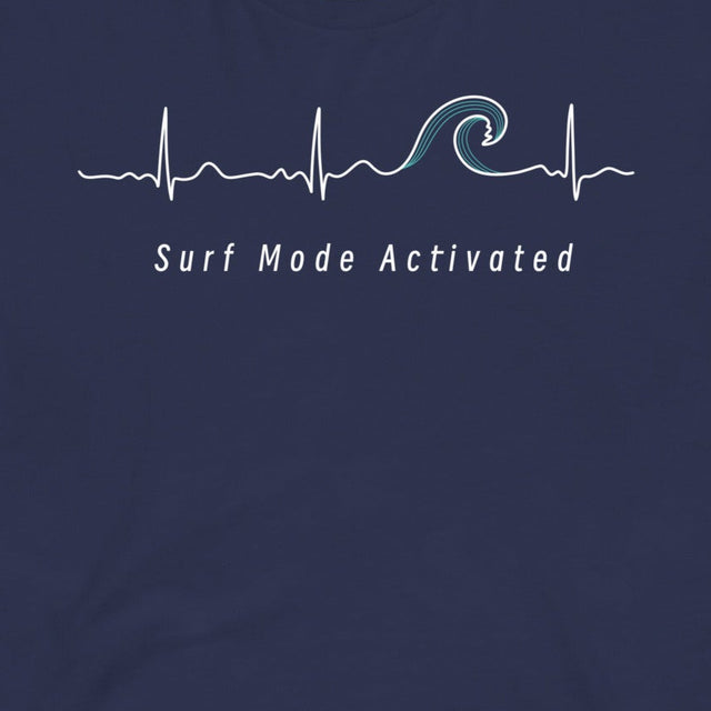 Closeup of the Heartbeat Surf Tee in dark blue featuring an ECG‑style minimalist heartbeat line flowing into a surf wave with the text ‘Surf Mode Activated,’ printed in crisp white on soft navy cotton fabric
