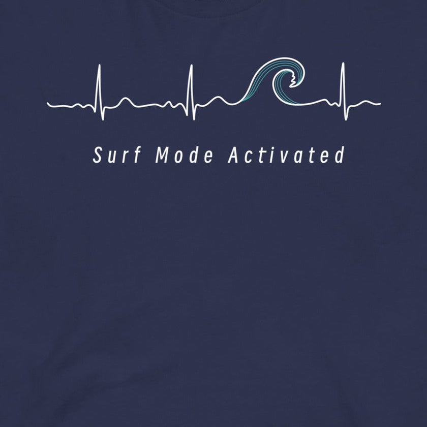 Closeup of the Heartbeat Surf Tee in dark blue featuring an ECG‑style minimalist heartbeat line flowing into a surf wave with the text ‘Surf Mode Activated,’ printed in crisp white on soft navy cotton fabric