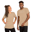 Model wearing the beige Heartbeat Surf Tee with the minimalist ECG‑inspired heartbeat‑wave graphic and ‘Surf Mode Activated’ text, styled in a bright, summery coastal look
