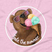 Closeup of a cute brown bear wearing white sunglasses with pink lenses, happily licking a triple‑scoop ice cream and smiling with its mouth open, printed on a light pink tee