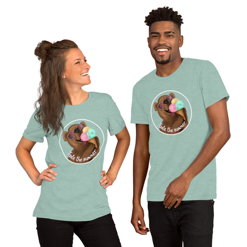 Model mockup of a sage green tee with a kawaii brown bear wearing white sunglasses with pink lenses, enjoying a triple‑scoop ice cream and smiling with its mouth open