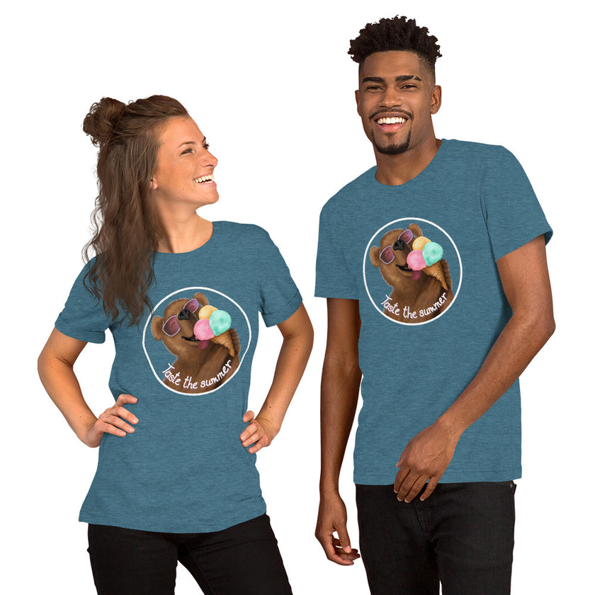 Model mockup of a slate teal tee with a cute brown bear wearing white sunglasses with pink lenses, enjoying a triple‑scoop ice cream with its mouth open and tongue out