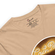 Detail shot of a couch potato illustration and a brand label, printed on a beige tee