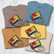 Folded Retro Vibes Cassette Tees in all five available colors, each showing the vintage cassette graphic with heart‑shaped tape.
