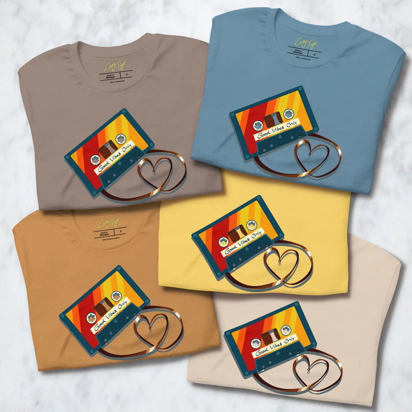Folded Retro Vibes Cassette Tees in all five available colors, each showing the vintage cassette graphic with heart‑shaped tape.