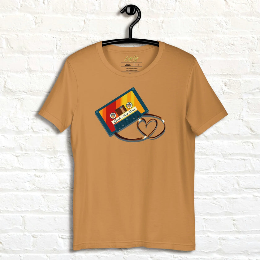 Mustard Retro Vibes Cassette Tee on a hanger, highlighting the vibrant cassette graphic and heart‑shaped tape loop.