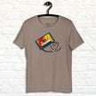 Taupe Retro Vibes Cassette Tee hanging against a white wall, showing the colorful retro cassette illustration with heart‑shaped tape.