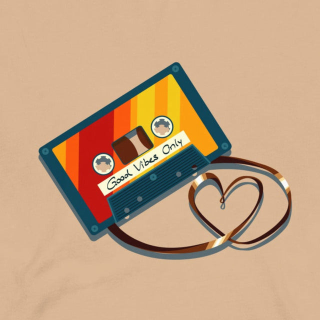Closeup of a retro cassette in bold vintage colors with its tape forming a heart shape, printed on a beige tee
