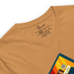 Detail shot of the vintage cassette and a brand label on a mustard yellow tee