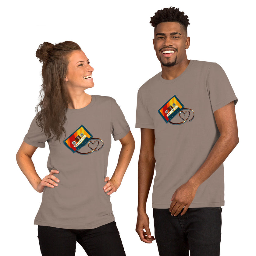 Model mockup of a taupe tee with a colorful vintage cassette and heart‑shaped tape loop