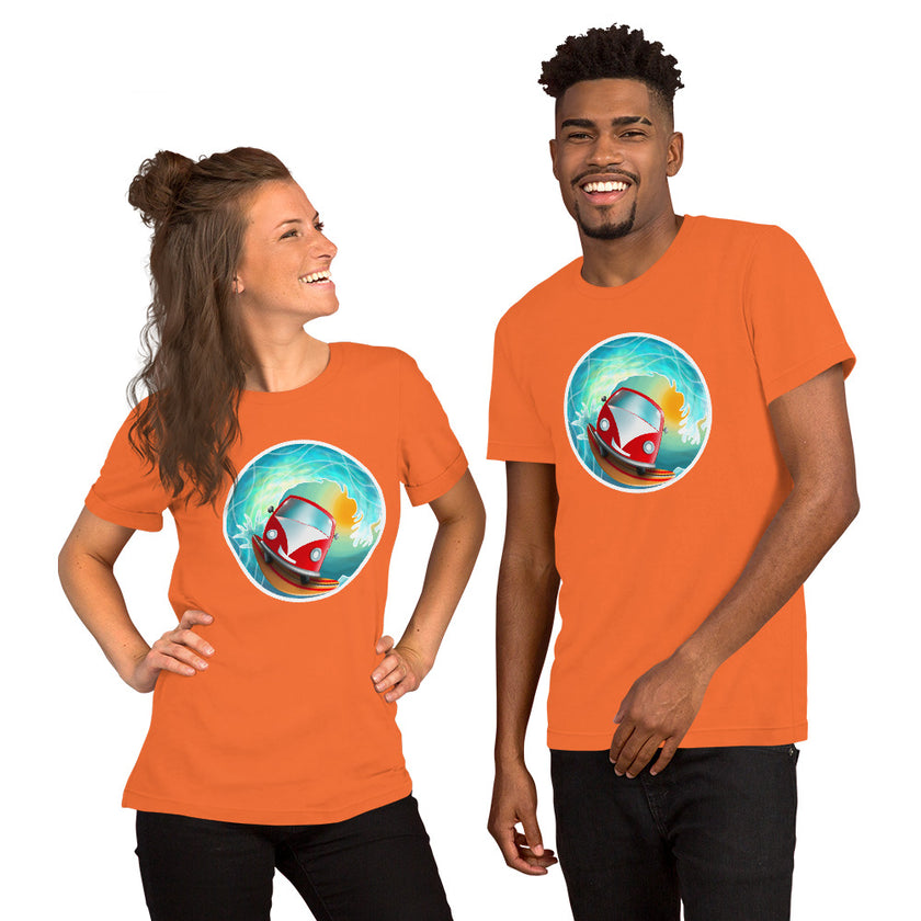 Studio mockup of an orange tee with a playful red vintage camper van surfing a big barrel wave lit by the sun